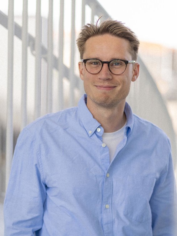 Young man with glasses looking at the camera